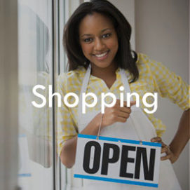 African American business owner with Ã¢'open' sign